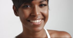 Gorgeous black young woman dancing and posing video. white body suit, ideal skin,